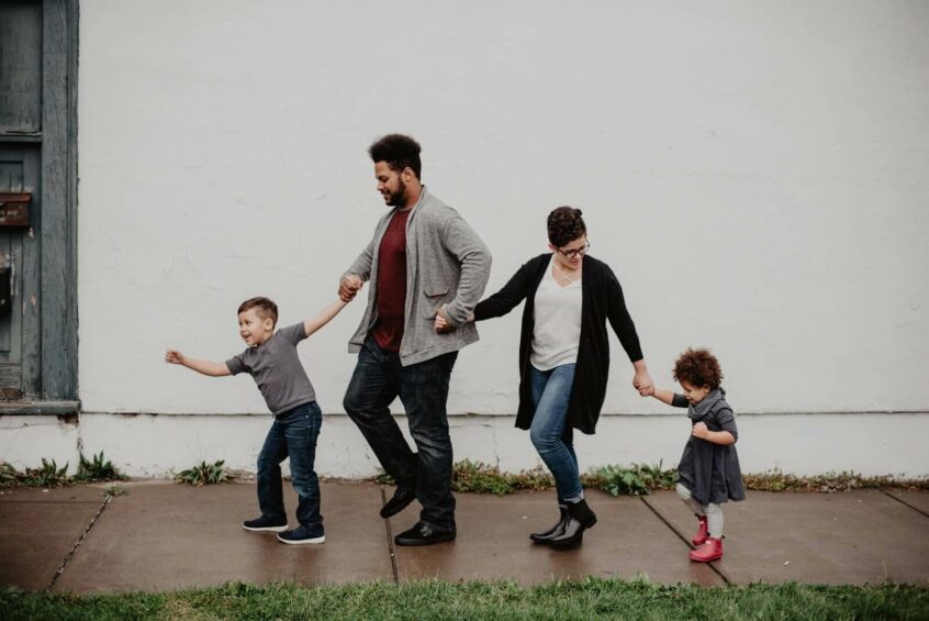 a group of people walking on a sidewalk