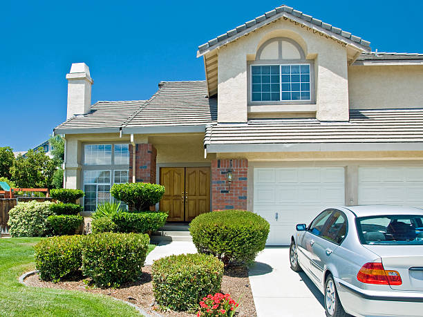 A house with a car parked in front of it