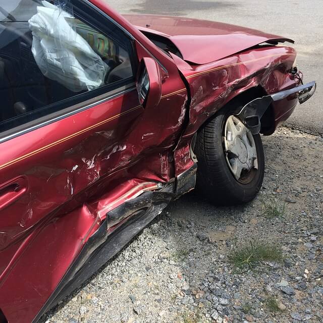 A car with a damaged front end caused by an accident with an uninsured motorist in Branson, MO.