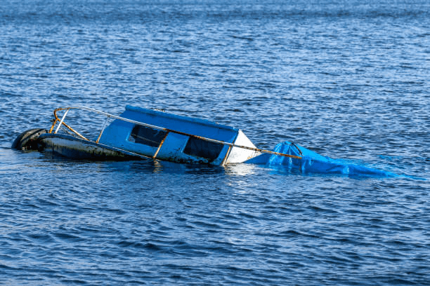 A boat is seen floating effortlessly on the tranquil surface of the water of Branson, MO.