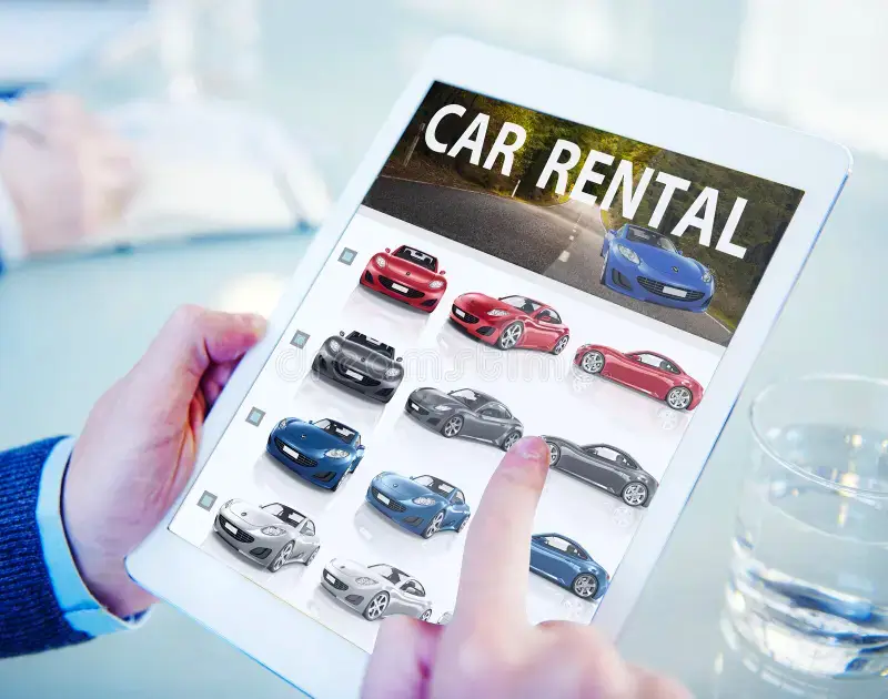a person holding a tablet with a screen showing a car rental