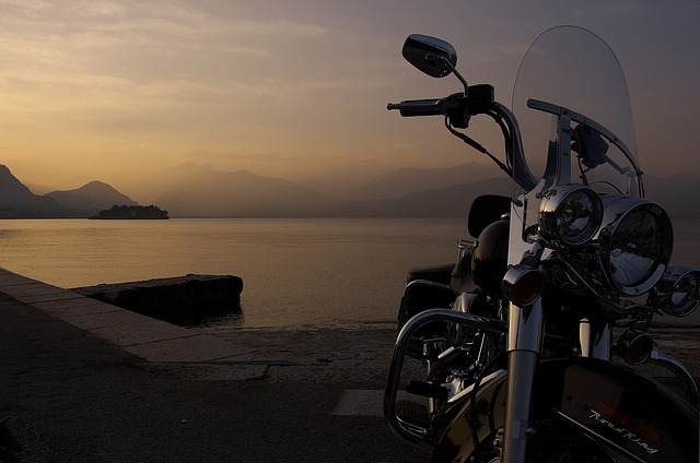a motorcycle parked on the side of a road near the beach