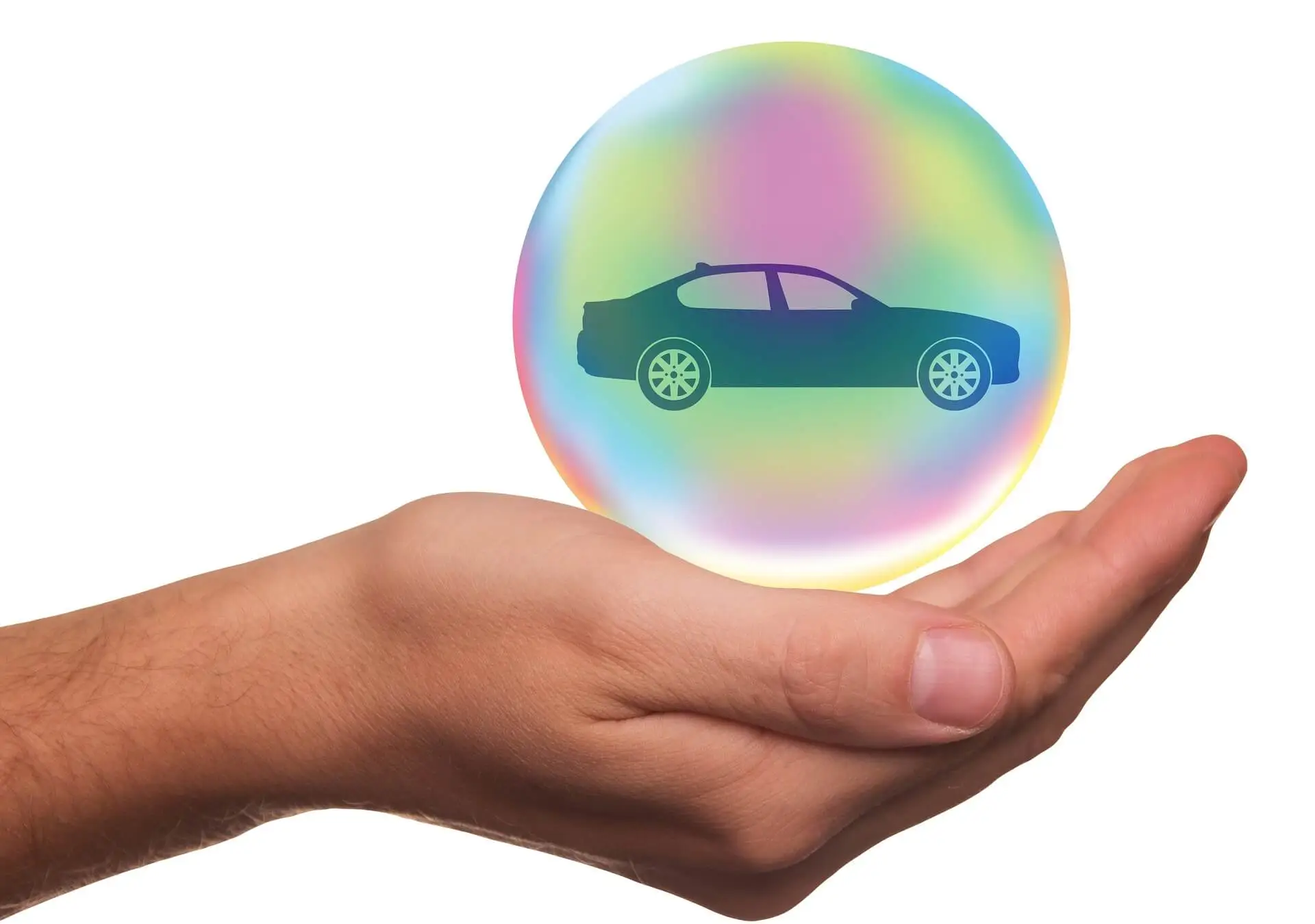 a hand holding a bubble with a car in it